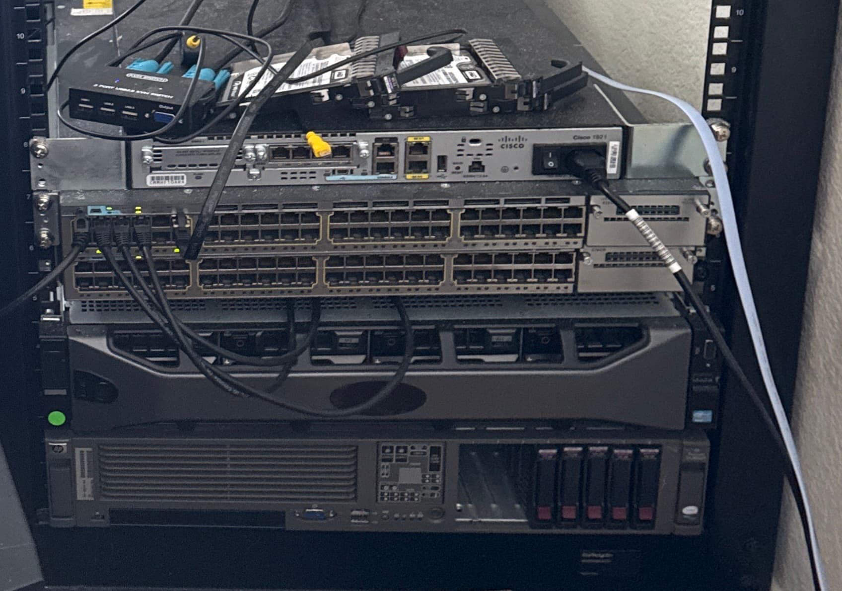 Rack-mounted Dell PowerEdge server and Cisco switch in an open-frame server rack